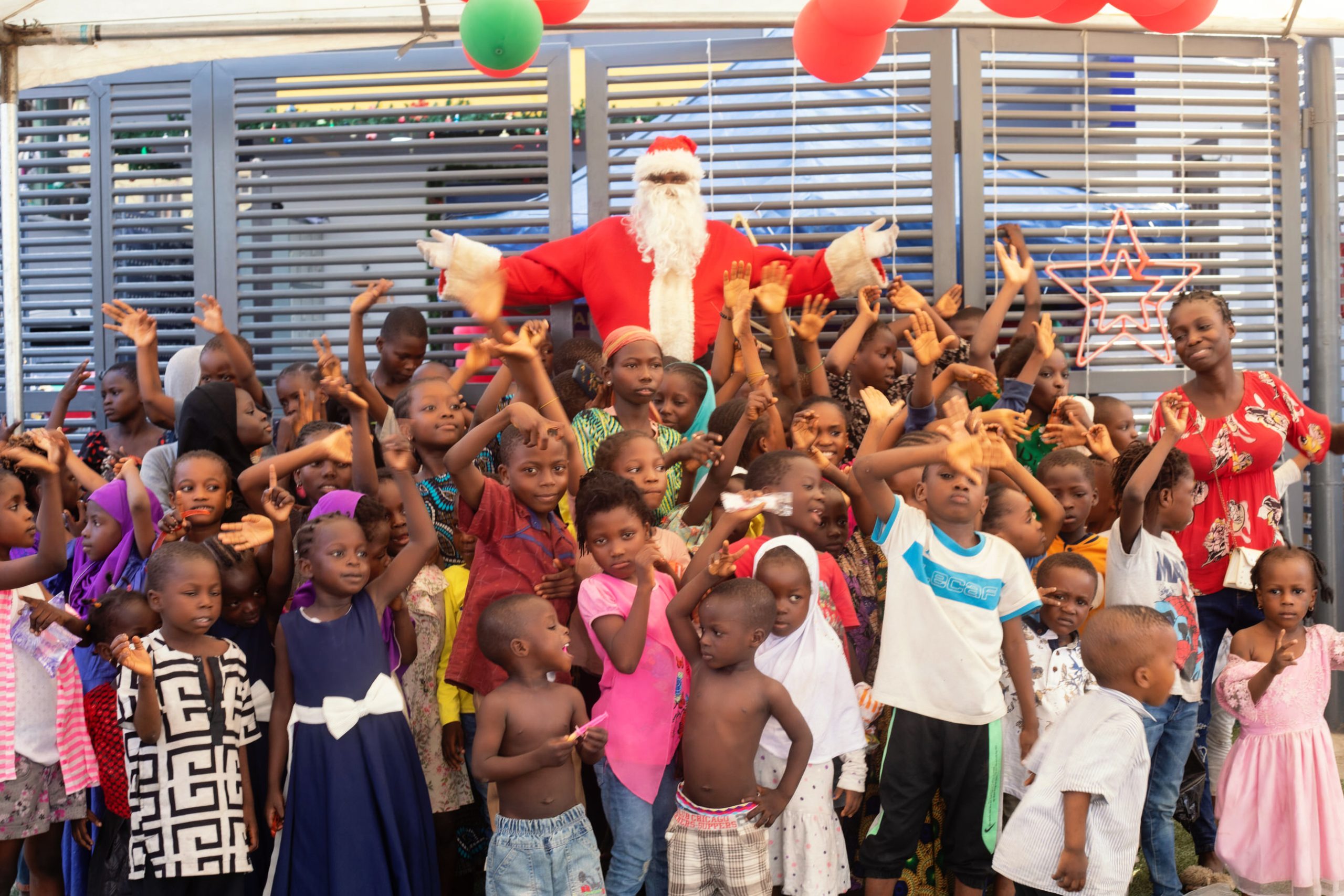 Addosser celebrates with children in Sangrouse community.